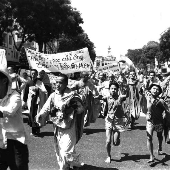 Faas running with demonstrating Buddhist monks, Saigon, 1963