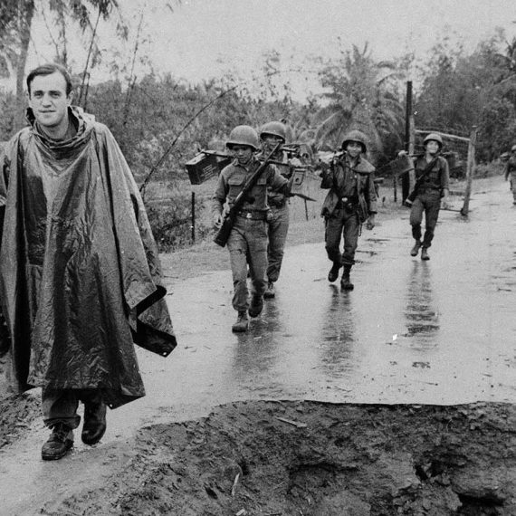 Arnett on patrol in rain with South Vietnamese soldiers, circa 1963