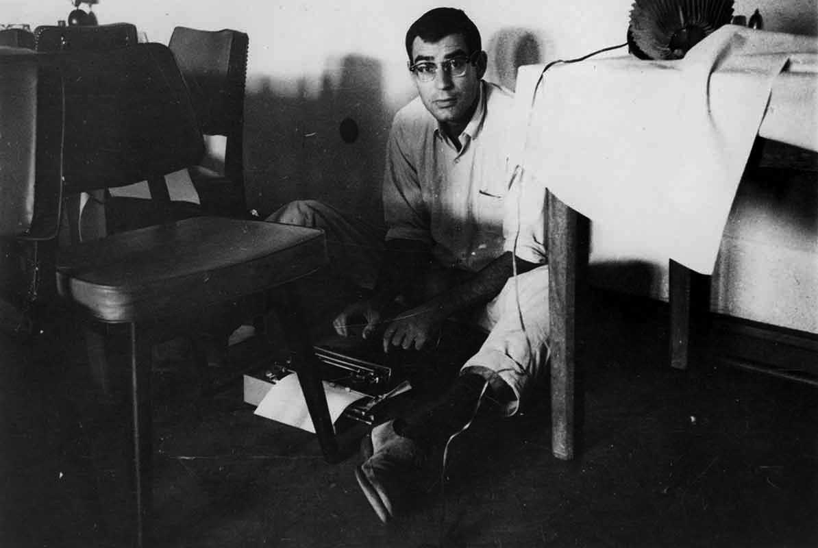 Halberstam bangs out a story in his Olivetti portable typewriter, Saigon, 1963
